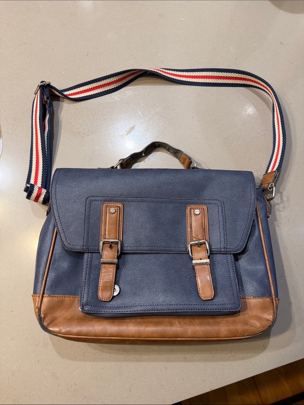 Aldo Navy Messenger Bag with Brown Trim and Striped Strap
